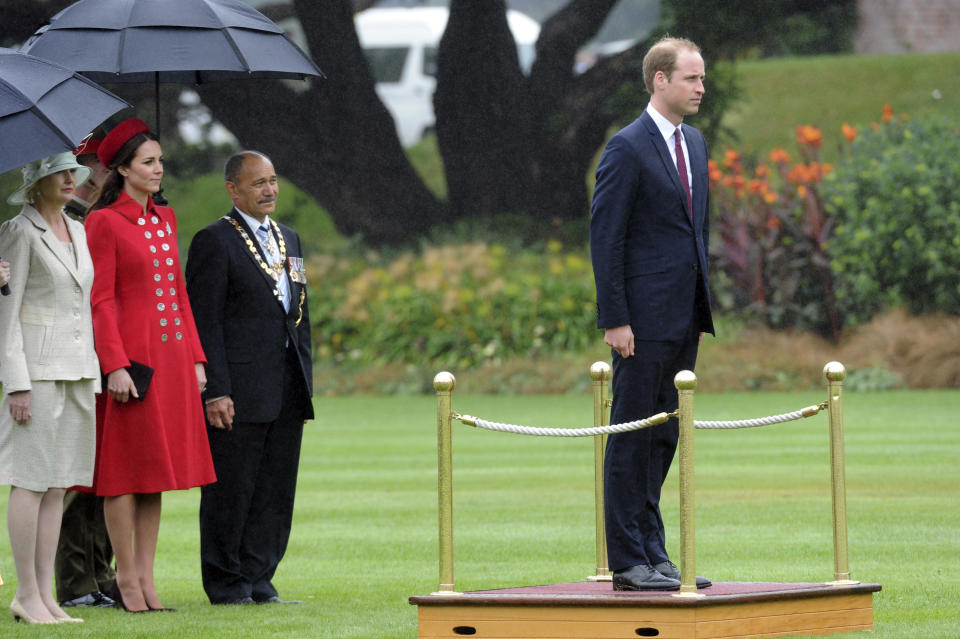 Britain's Prince William takes a Royal Salute watched by Catherine, Duchess of Cambridge, and the Governor General of New Zealand Sir Jerry Mateparae, at the official welcome at Government House, in Wellington, New Zealand, Monday, April 7, 2014. (AP Photo/SNPA, Ross Setford) NEW ZEALAND OUT