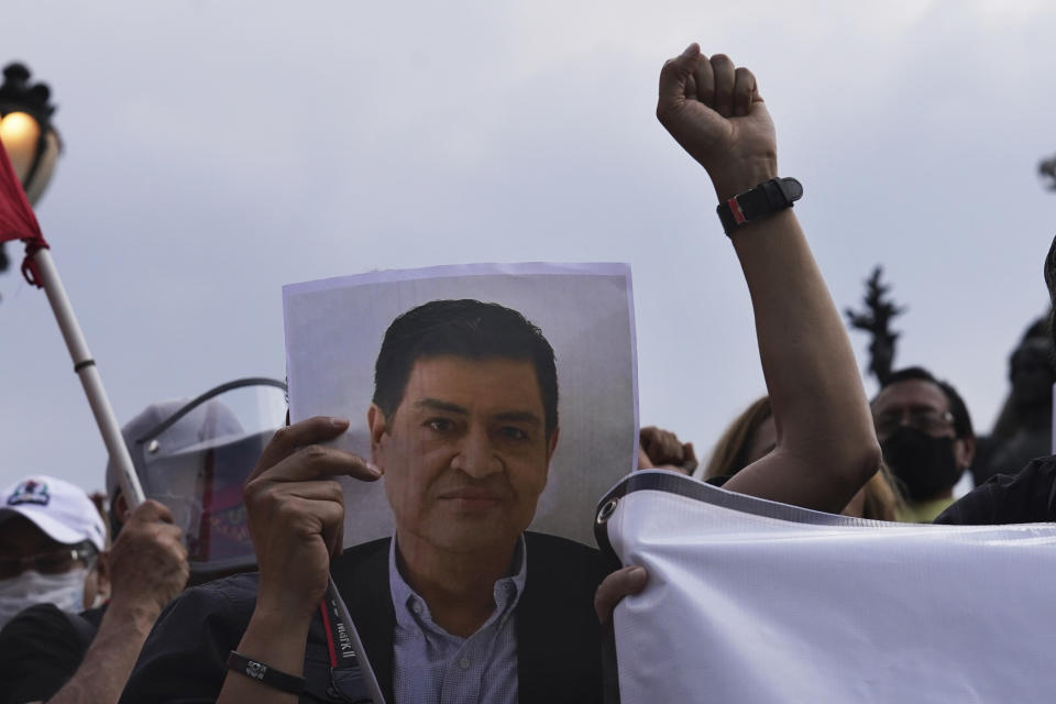 A journalist holds a photo of Luis Enrique Ramirez who was murdered on May 6, 2022, during a protest to draw attention to the latest wave of murders of journalists, at the Angel of Independence monument in Mexico City, on Monday, May 9, 2022. Two journalists were shot dead in the state of Veracruz, on the Gulf Coast of Mexico, on Monday, Yessenia Mollinedo Falconi and Sheila Johana García Olivera, director and reporter, respectively, of the online news site El Veraz in Cosoleacaque. (AP Photo/Marco Ugarte)