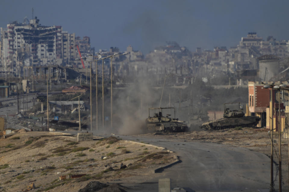 Israeli army tanks are seen in Wadi Gaza, central Gaza Strip, Wednesday, June 26, 2024. (AP Photo/Abdel Kareem Hana)