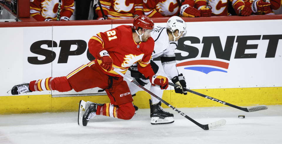 Los Angeles Kings forward Blake Lizotte (46) is checked by Calgary Flames forward Kevin Rooney (21) during the third period of an NHL hockey game, Tuesday, Feb. 27, 2024 in Calgary, Alberta. (Jeff McIntosh/The Canadian Press via AP)