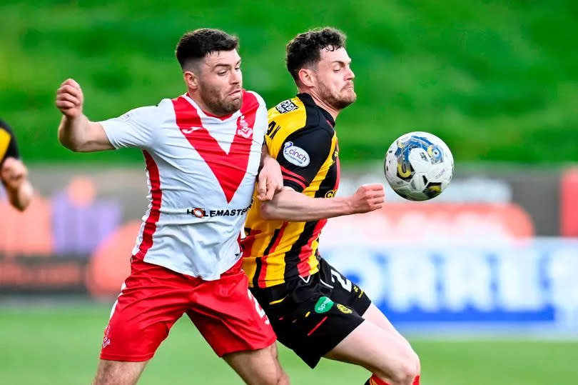 Airdrie skipper Cammy Ballantyne tussles with Partick Thistle's Jack McMillan as the sides clash at Firhill