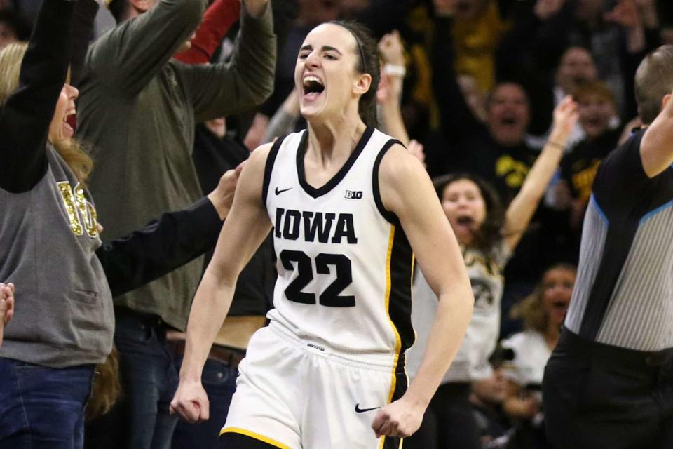 <p>Matthew Holst/Getty </p> Caitlin Clark #22 of the Iowa Hawkeyes celebrates after breaking the NCAA women