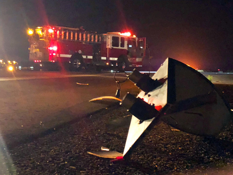 This Sunday, Aug. 25, 2019 photo provided by the Santa Barbara County Fire Department shows the wreckage of a Lockheed C-130 cargo pane after it crashed and burned at the Santa Barbara, Calif., Airport. Authorities say seven people escaped unhurt. The Federal Aviation Administration says the plane experienced hydraulic problems and crash-landed on its belly along a runway. (Mike Eliason/Santa Barbara County Fire Department via AP)