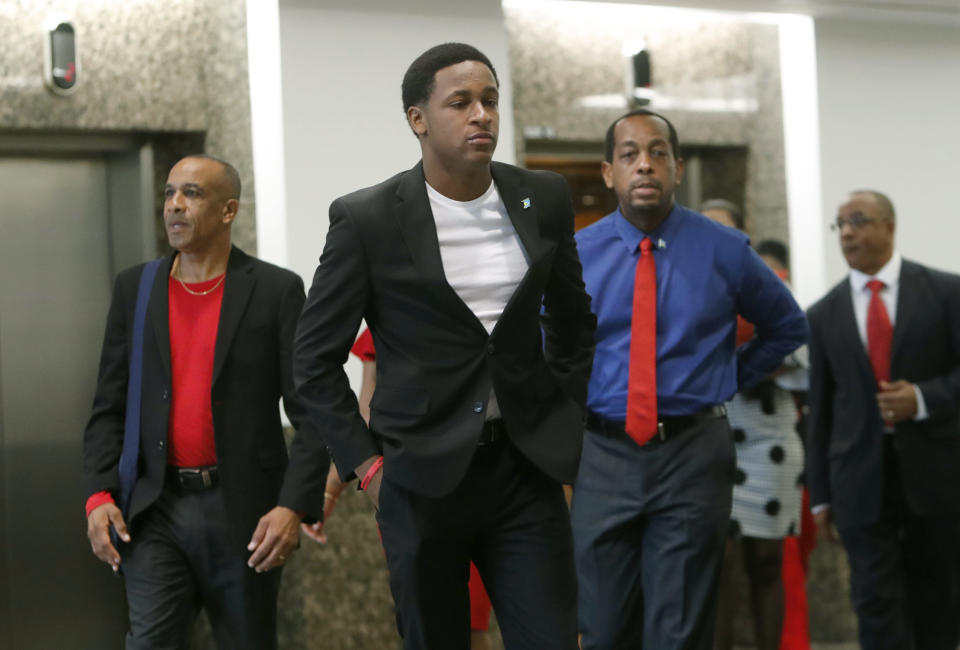 Brandt Jean, center, the brother of Botham Jean arrives with family members for the murder trial of former Dallas police officer Amber Guyger in Dallas, Tuesday, Sept. 24, 2019. Guyger is on trial for shooting and killing Botham Jean, her unarmed neighbor, in the Dallas apartment building they both lived in. (AP Photo/LM Otero)