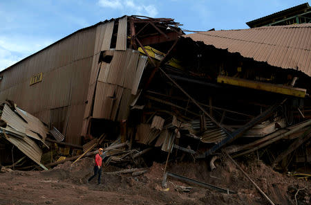 FILE PHOTO: A member of a rescue team walks next to a collapsed tailings dam owned by Brazilian mining company Vale SA, in Brumadinho, Brazil February 13, 2019. REUTERS/Washington Alves/File Photo