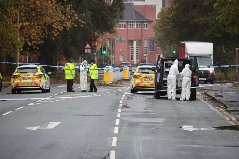 Police and forensic officers on Moss Lane East -Credit:Manchester Evening News