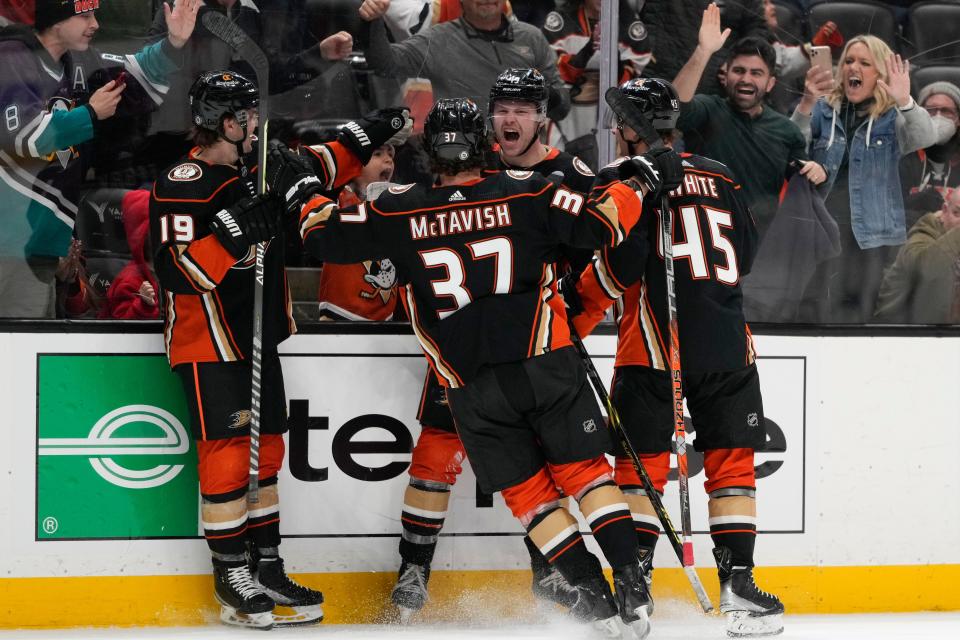 Anaheim Ducks' Max Jones (49) celebrates his goal with teammates during the third period of an NHL hockey game against the Columbus Blue Jackets Friday, March 17, 2023, in Anaheim, Calif. (AP Photo/Jae C. Hong)