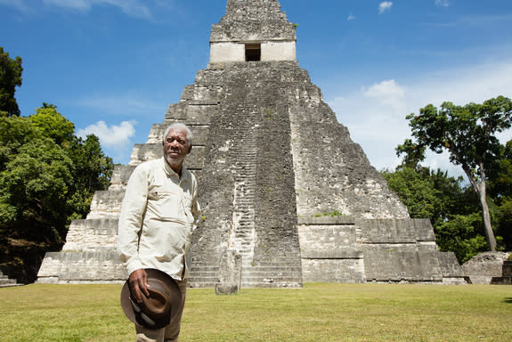 Morgan Freeman stands in front of Tikal, Mayan ruins in Guatemala.