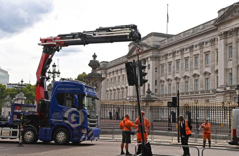 Workers re-install traffic lights after Queen Elizabeth's funeral