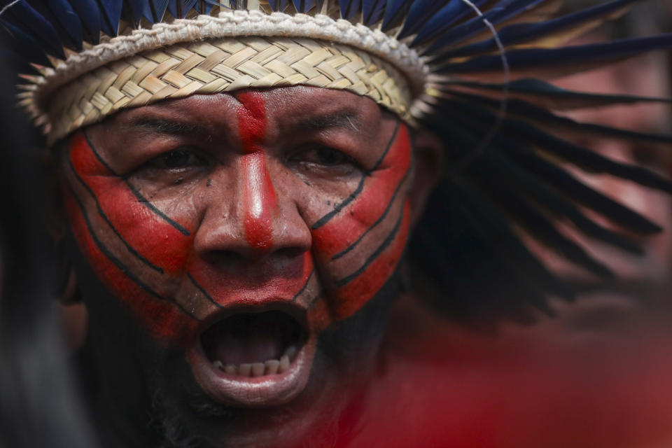 An Indigenous man attends the opening ceremony of the 20th annual Free Land Indigenous Camp in Brasilia, Brazil, Monday, April 22, 2024. The 7-day event aims to show the unity of Brazil's Indigenous peoples in their fight for the demarcation of their lands and their rights. (AP Photo/Luis Nova)