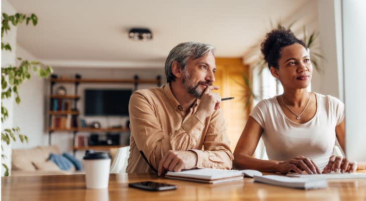 A married couple looks over their finances as they plan for their eventual retirement.