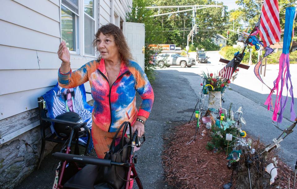 Rosemary Gleason pays tribute to her son, David, at the site of the motorcycle crash.