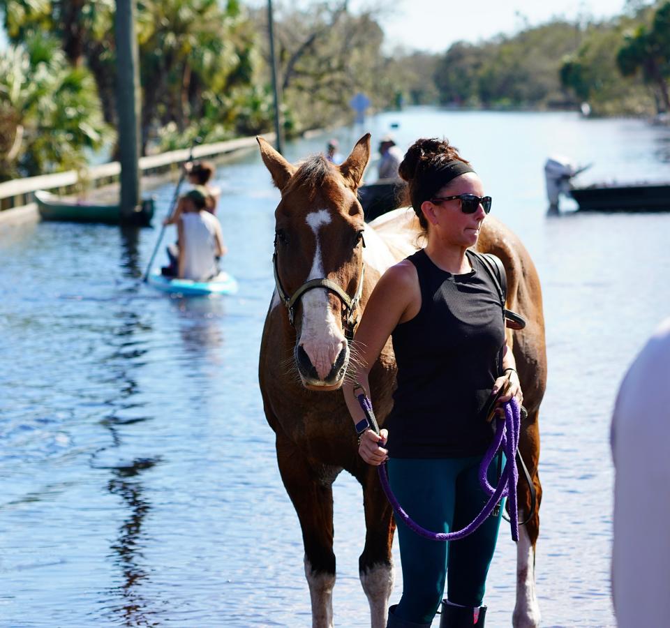 Chelsea Sunderman, 33, rode Ringo through floodwaters to safety on, Oct. 1, 2022, near Venice, Florida, as the Myakka River levels rose.