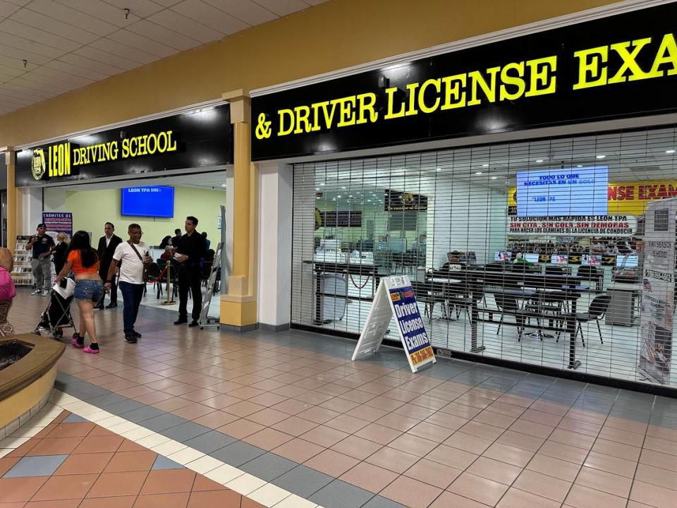 Leon Driving School offers driving instruction and immigration services at Midway Crossings. Here, employees hand out cards to passing mall patrons on May 30, 2024.