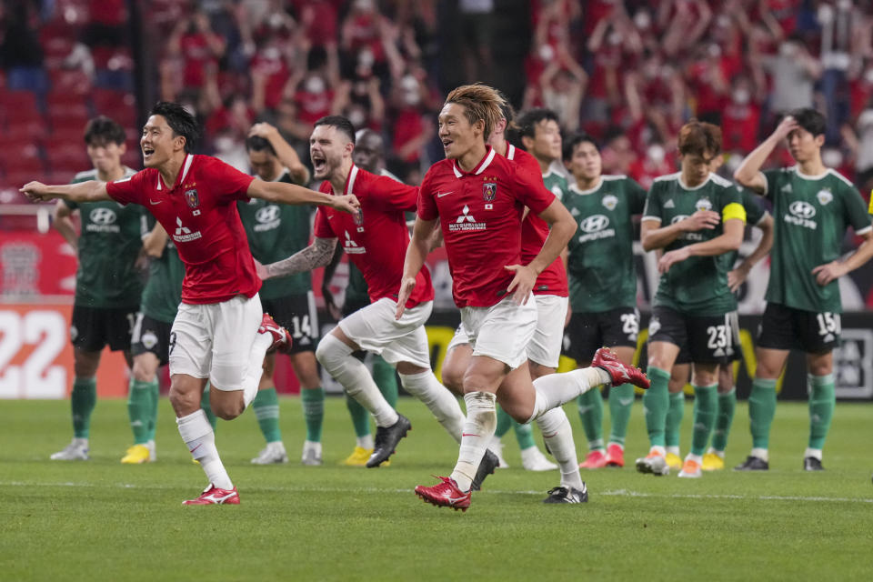 Japan's Urawa Red Diamonds' players celebrate after winning the AFC Champions League semifinal match against Jeonbuk Hyundai Motors in a penalty shoot-out at Saitama Stadium Thursday, Aug. 25, 2022, in Saitama, near Tokyo. (AP Photo/Eugene Hoshiko)