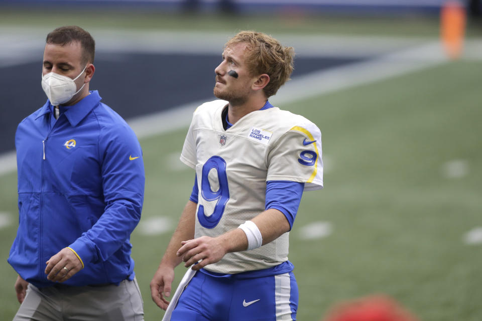 Los Angeles Rams quarterback John Wolford (9) walks off the field after being injured during the first half of an NFL wild-card playoff football game against the Seattle Seahawks, Saturday, Jan. 9, 2021, in Seattle. (AP Photo/Scott Eklund)