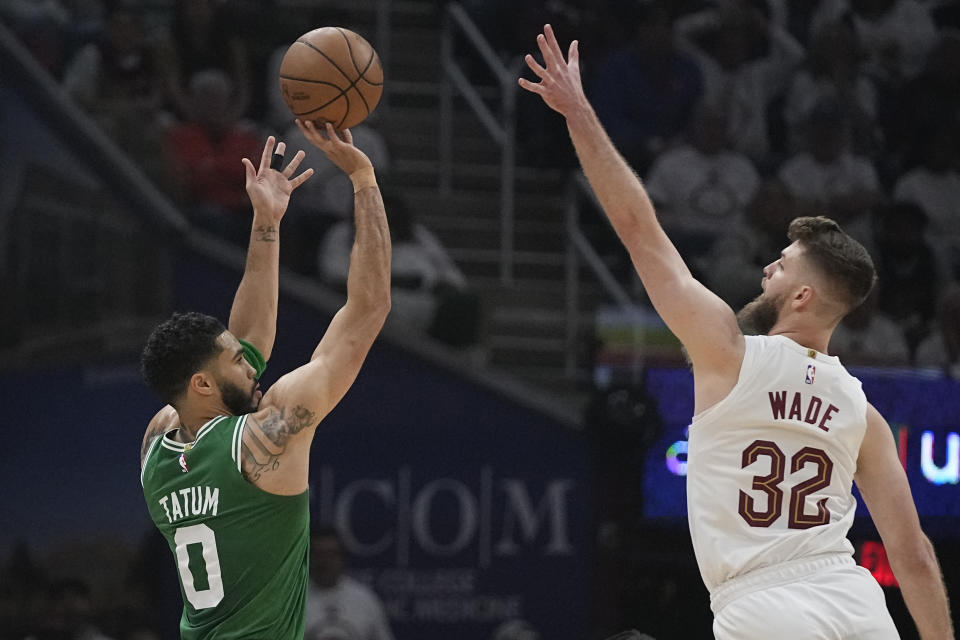 Boston Celtics forward Jayson Tatum (0) shoots as Cleveland Cavaliers forward Dean Wade (32) defends during the first half of Game 3 of an NBA basketball second-round playoff series Saturday, May 11, 2024, in Cleveland. (AP Photo/Sue Ogrocki)