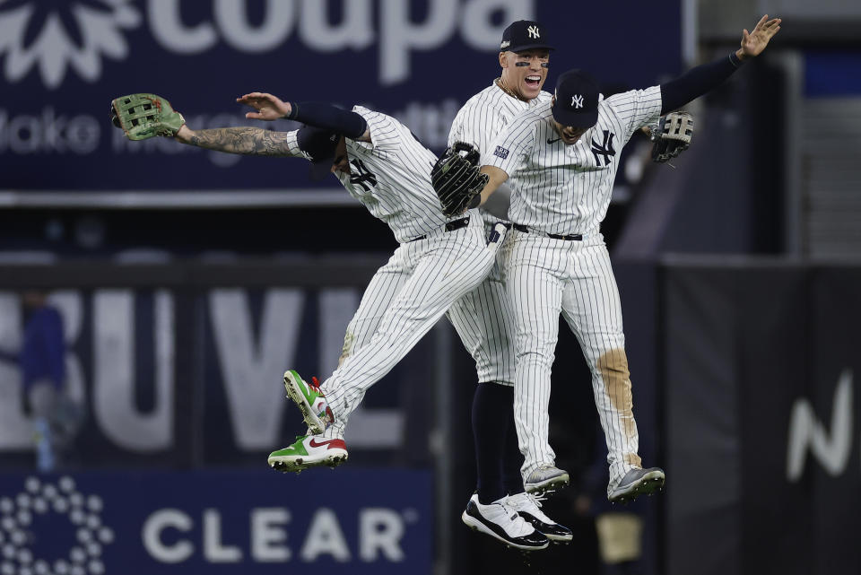 New York Yankees left fielder Alex Verdugo, left, center fielder Aaron Judge, center, and Juan Soto celebrate after beating the Kansas City Royals in Game 1 of the American League baseball division series, Saturday, Oct. 5, 2024, in New York. (AP Photo/Adam Hunger)