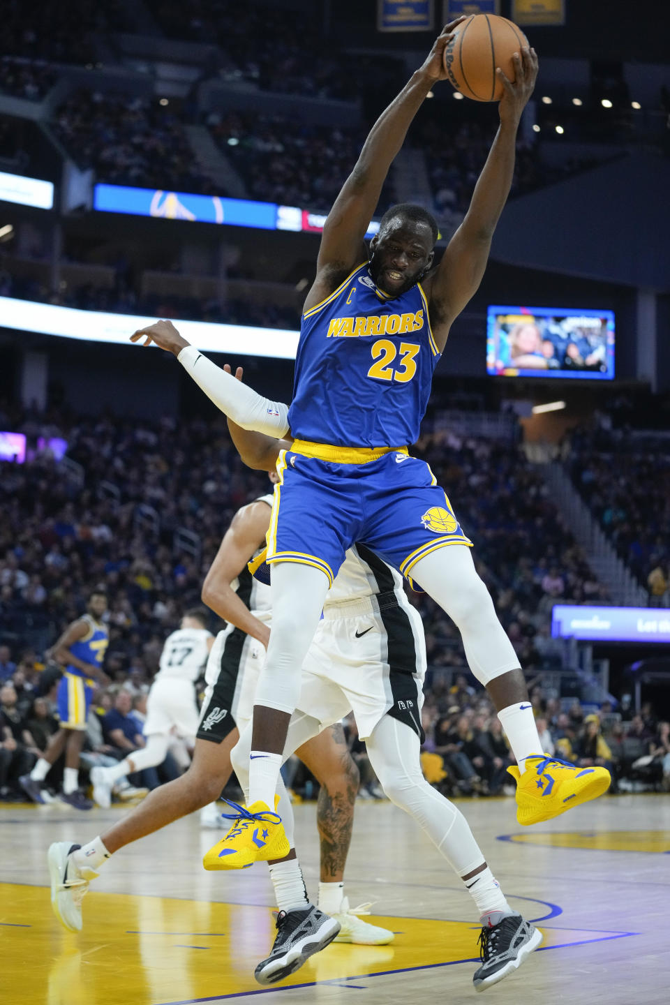 Golden State Warriors forward Draymond Green (23) rebounds the ball against the San Antonio Spurs during the first half of an NBA basketball game in San Francisco, Monday, Nov. 14, 2022. (AP Photo/Godofredo A. Vásquez)