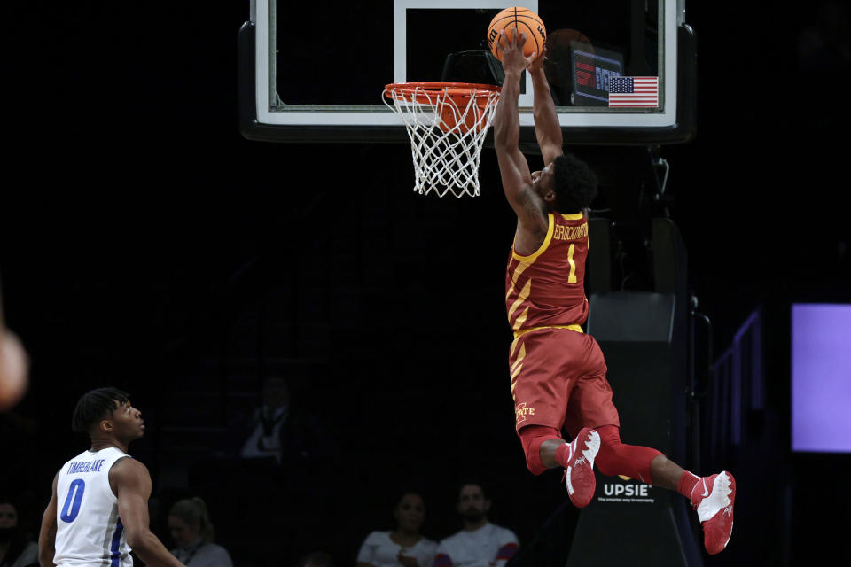 Iowa State's Izaiah Brockington (1) dunks near Memphis' Earl Timberlake during the second half of an NCAA college basketball game in the NIT Season Tip-Off tournament Friday, Nov. 26, 2021, in New York. Iowa State won 78-59. (AP Photo/Adam Hunger)