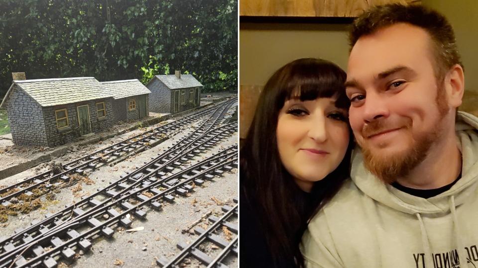 Lauren and Sean Grundy with a model train set in the garden