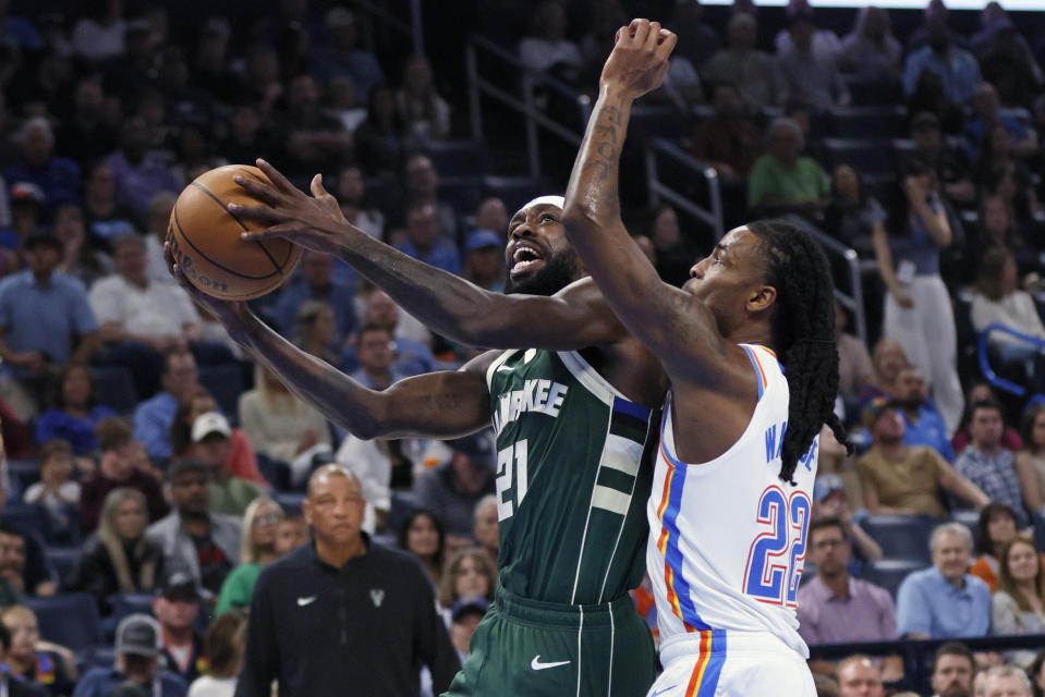 Milwaukee Bucks guard Patrick Beverley (21) prepares to shoot against Oklahoma City Thunder guard Cason Wallace (22) during the first half of an NBA basketball game Friday, April 12, 2024, in Oklahoma City. (AP Photo/Nate Billings)