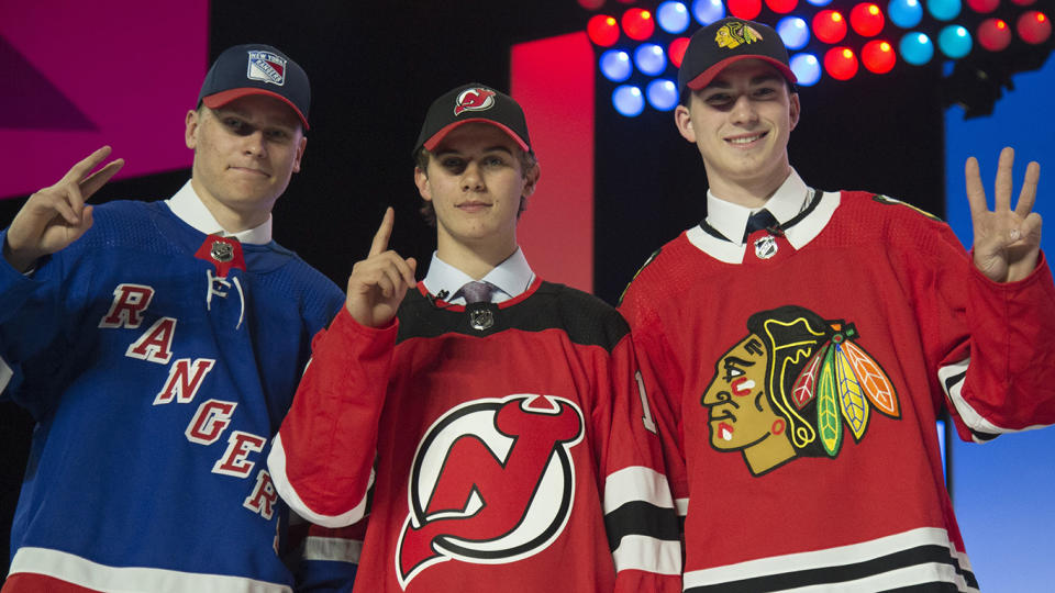 Draft picks from left to right, New York Rangers Kaapo Kakko, New Jersey Devils Jack Hughes and Chicago Blackhawks Kirby Dach during the first round NHL draft at Rogers Arena in Vancouver, Friday, June, 21, 2019. THE CANADIAN PRESS/Jonathan Hayward