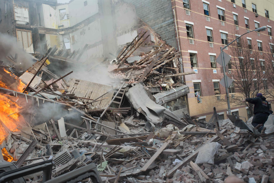 Emergency workers respond to the scene of an explosion that leveled two apartment buildings in the East Harlem neighborhood of New York, Wednesday, March 12, 2014. Con Edison spokesman Bob McGee says a resident from a building adjacent to the two that collapsed reported that he smelled gas inside his apartment, but thought the odor could be coming from outside. (AP Photo/Jeremy Sailing)