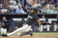 Miami Marlins' Jesus Sanchez reacts after being hit by a pitch during the third inning of a baseball game against the New York Mets, Friday, May 17, 2024, in Miami. (AP Photo/Wilfredo Lee)