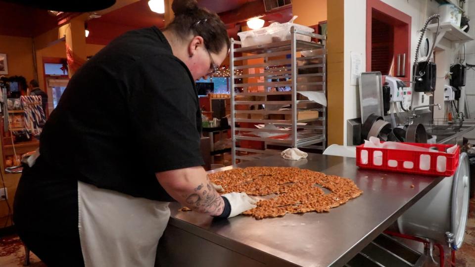 Head confectioner Brenda Priest works away on peanut brittle in house.