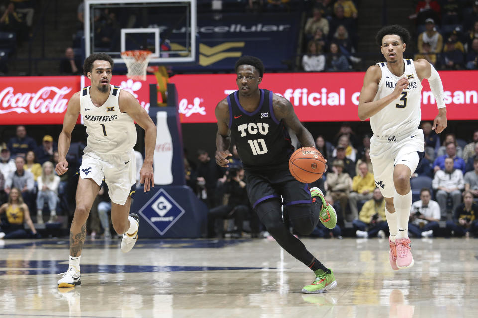 TCU guard Damion Baugh (10) is trailed by West Virginia forwards Emmitt Matthews Jr. (1) and Tre Mitchell (3) during the first half of an NCAA college basketball game Wednesday, Jan. 18, 2023, in Morgantown, W.Va. (AP Photo/Kathleen Batten)