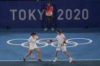 Anastasia Pavlyuchenkova and Andrey Rublev, of the Russian Olympic Committee, react to a point during the mixed doubles gold medal match of the tennis competition at the 2020 Summer Olympics, Sunday, Aug. 1, 2021, in Tokyo, Japan. (AP Photo/Seth Wenig)