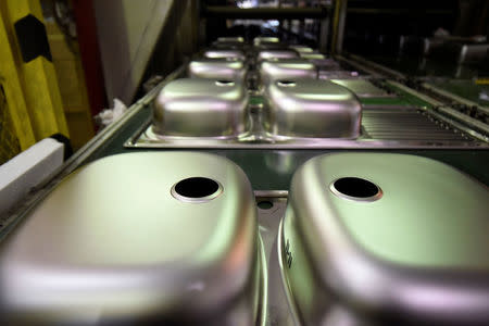 FILE PHOTO: Stainless steel sinks are seen at the production line of the Pyramis Metallourgia manufacturing facility in Thessaloniki, Greece, November 2, 2017. REUTERS/Alexandros Avramidis/File Photo