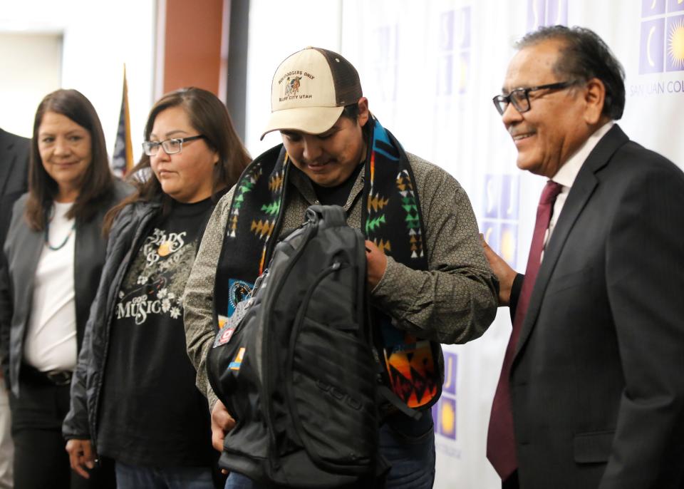 Navajo Technical University student Jared Pino checks out the backpack he received on May 10 in Farmington from the Public Service Company of New Mexico during a reception to recognize his graduation and participation in the PNM Navajo Nation Workforce Training Initiative.
