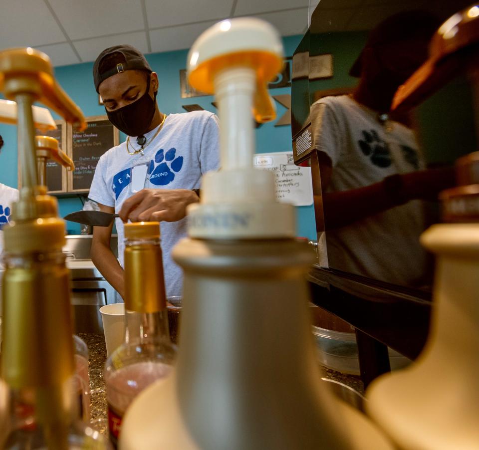 A student creates a Linda's Shot in the Dark Latte at Dallastown's Common Grounds Café.