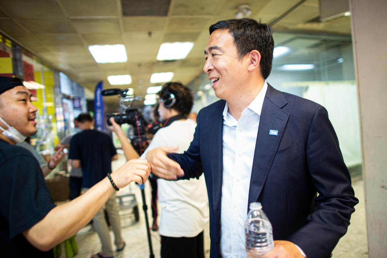 New York City mayoral candidate Andrew Yang greets a supporter at the unveiling of a mural in Chinatown on Sunday, June 20, in New York City. 