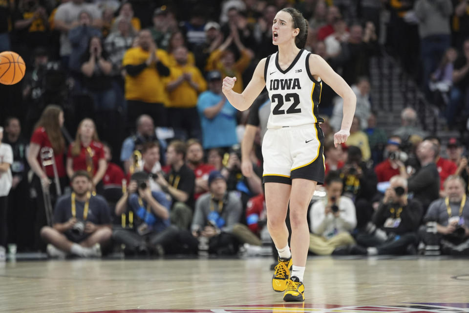 Iowa guard Caitlin Clark (22) cheers after forcing overtime as time expires to end the second half of an NCAA college basketball game against Nebraska in the final of the Big Ten women's tournament Sunday, March 10, 2024, in Minneapolis. (AP Photo/Abbie Parr)