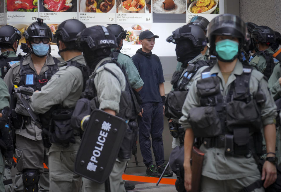 A protester is detained by police during the annual handover march in Hong Kong, Wednesday, July. 1, 2020. Hong Kong marked the 23rd anniversary of its handover to China in 1997, and just one day after China enacted a national security law that cracks down on protests in the territory. Hong Kong police said on Facebook they had arrested over 30 people on various charges, from unlawful assembly to the violation of a national security law on the first day of the law. (AP Photo/Vincent Yu)