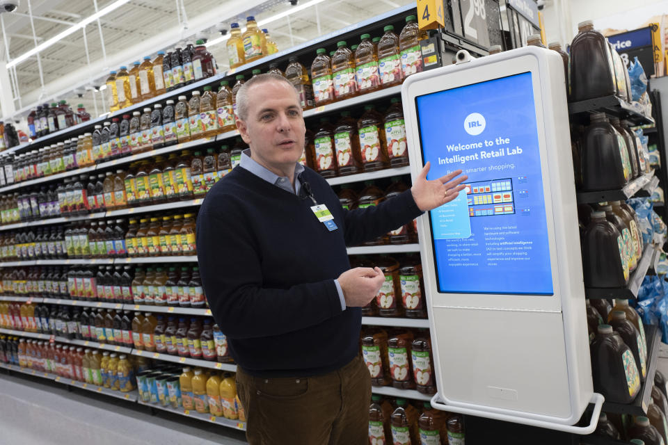 Mike Hanrahan, CEO of Walmart's Intelligent Retail Lab, discusses a kiosk that describes to customers the high technology in use at a Walmart Neighborhood Market, Wednesday, April 24, 2019, in Levittown, N.Y. "If we know in real time everything that's happening in the store from an inventory and in stock perspective, that really helps us rethink about how we can potentially manage the store," said Hanrahan. (AP Photo/Mark Lennihan)