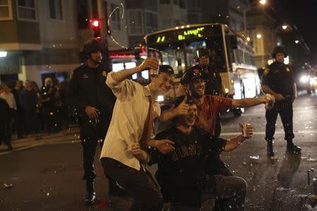 Fans celebrate in the street in the Mission District after the San Francisco Giants defeated the Kansas City Royals in Game 7 of the World Series, in San Francisco, California October 29, 2014. REUTERS/Robert Galbraith