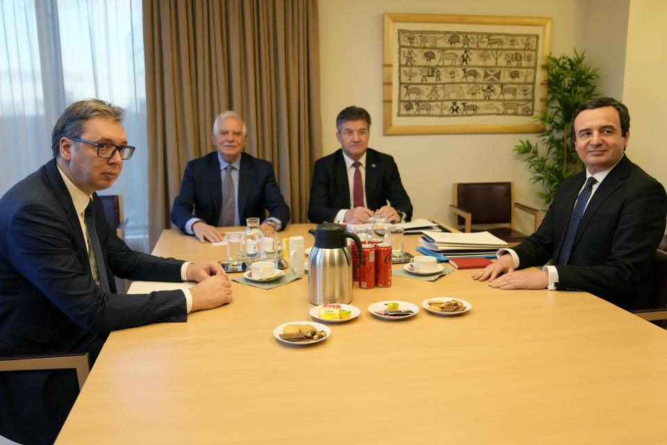 Serbian President Aleksandar Vucic, left, and Kosovo's Prime Minister Albin Kurti, right, meet with European Union foreign policy chief Josep Borrell, second left, in Brussels, Monday, Feb. 27, 2023. The leaders of Serbia and Kosovo are holding talks Monday on European Union proposals aimed at ending a long series of political crises and setting the two on the path to better relations and ultimately mutual recognition. (AP Photo/Virginia Mayo)
