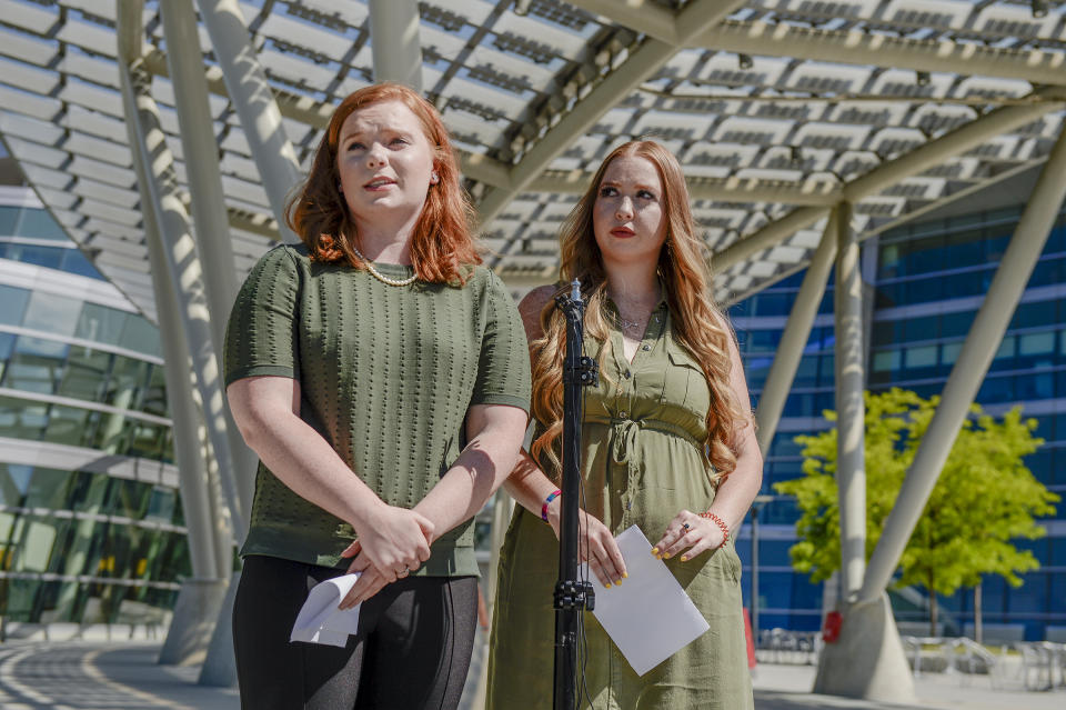 In this Sunday, June 23, 2019 photo, Ashley Fine and Kennedy Stoner, close friends of missing person Mackenzie Lueck, speak during a press conference outside the Salt Lake City Police Department in Salt Lake City. Police and friends are investigating the disappearance of the 23-year-old University of Utah student, whose last communication with her family said she arrived at Salt Lake City International Airport on Monday, June 17. (Leah Hogsten/The Salt Lake Tribune via AP)