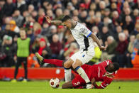 Liverpool's Ibrahima Konate, bottom, challenges Atalanta's Gianluca Scamacca during the Europa League quarter final first leg soccer match between Liverpool and Atalanta, at the Anfield stadium in Liverpool, England, Thursday, April 11, 2024. (AP Photo/Jon Super)