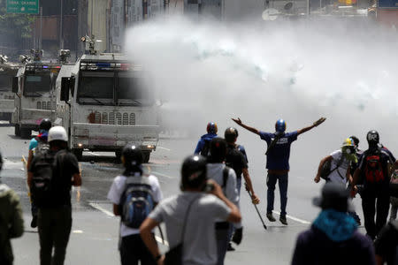 A jet of water is released on demonstrators during a rally against Venezuela's President Nicolas Maduro in Caracas, Venezuela, May 26, 2017. REUTERS/Marco Bello