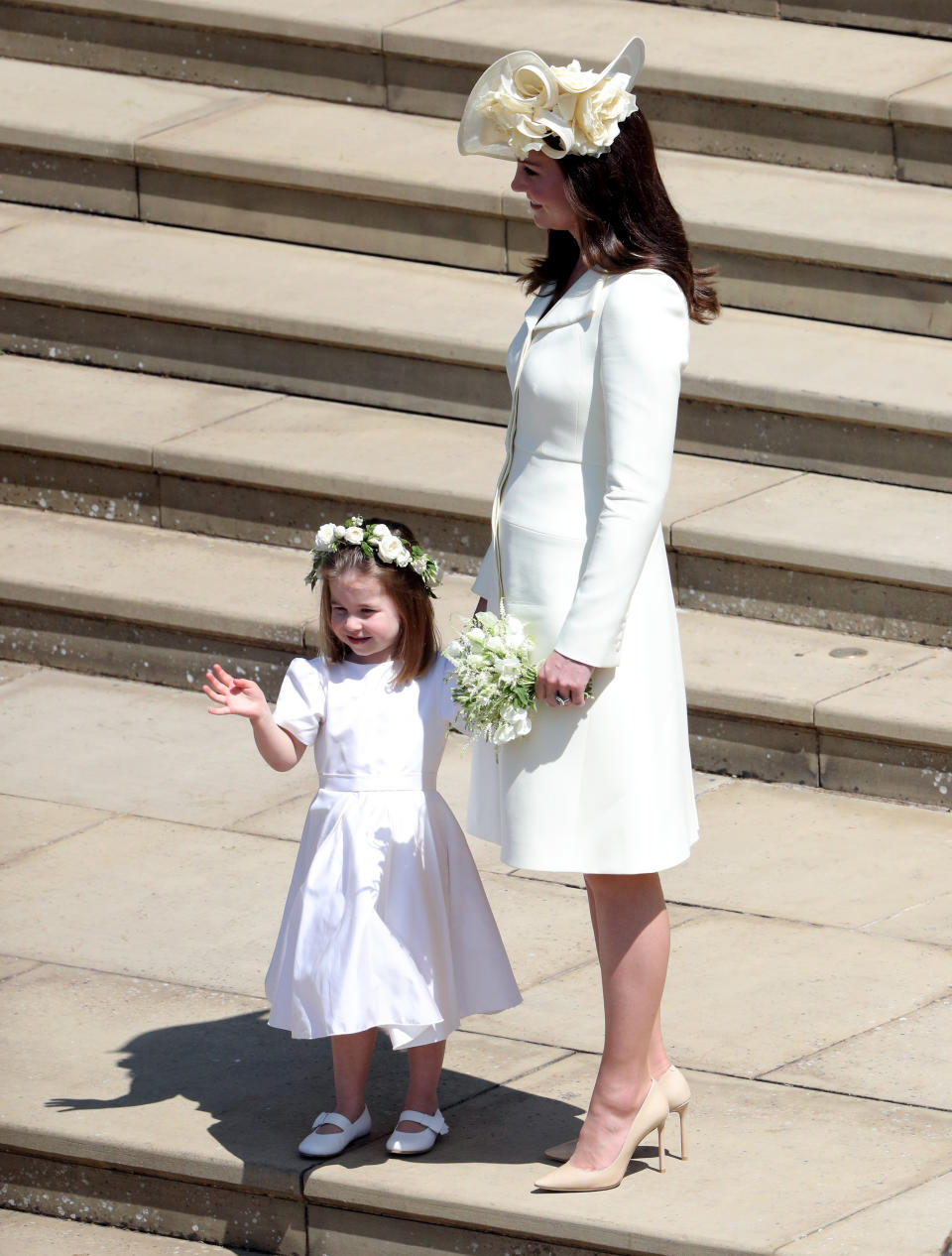 Princess Charlotte looked adorable dressed in white, standing next to her mother, Kate Middleton. Photo: AAP