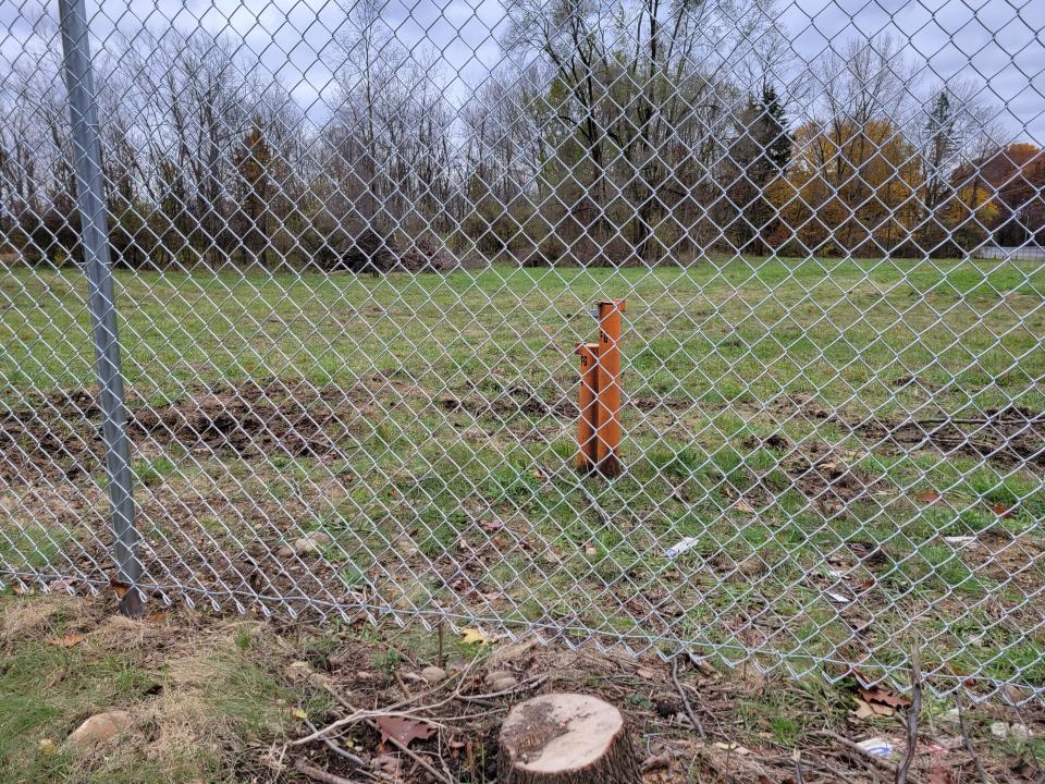 Methane emissions are monitored at pipes such as these at locations inside the fence at the former Industrial Excess Landfill in Lake Township.