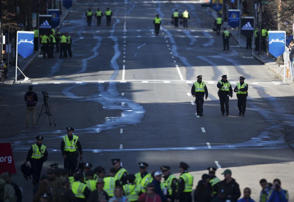 A heavy police presence stand guard in Boylston Street near the finish line of the Boston Marathon, April 21, 2014. REUTERS/Gretchen Ertl (UNITED STATES - Tags: SPORT ATHLETICS)