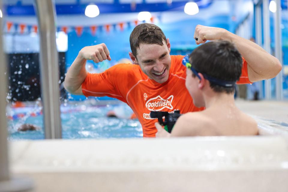 Olympic swimmer Ryan Murphy jokes with a student at the Goldfish Swim School in Milford, Dec. 2, 2023.