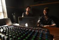 British folk singer Frank Turner discusses music production with Sierra Leonean producer Solo while the pair volunteer at the Way Out media studio in Freetown