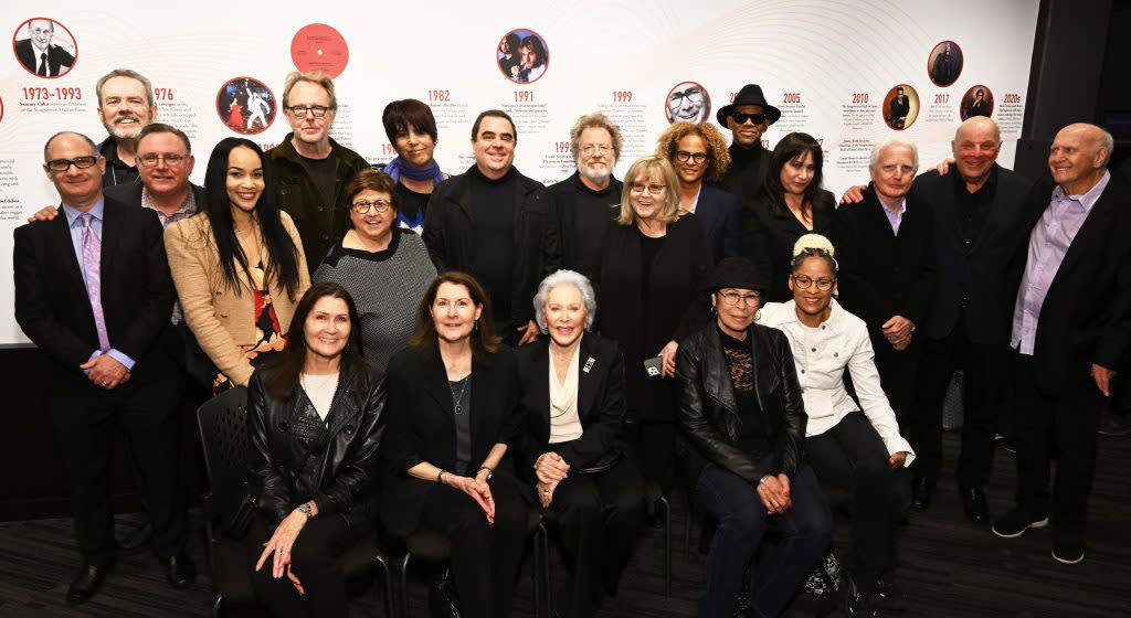 In Los Angeles, SHOF inductees and family members attend an exclusive VIP Preview of “The Power of Song: A Songwriters Hall of Fame Exhibit” at the GRAMMY Museum. Pictured Seated (L to R): SHOF Inductee Henry Mancini’s daughters Felice Mancini and Monica Mancini, SHOF Inductee and Past Chairman Hal David’s widow Eunice David, SHOF Inductee Bill Withers’ widow Marcia Withers and daughter Kori Withers. Middle Row (L to R): SHOF Founder Johnny Mercer’s grandsons Jon Corwin and Jim Corwin, SHOF Inductee Lamont Dozier’s daughter Desiree Dozier, SHOF Board Member/Chair, West Coast Projects Committee Mary Jo Mennella, SHOF President and CEO Linda Moran, SHOF Inductee Holly Knight, SHOF Inductee Billy Steinberg, SHOF Inductee Charles Fox, and SHOF Inductee Mike Stoller. Back Row (L to R): SHOF Inductee and Past Chairman Jimmy Webb, SHOF Inductee Rick Nowels, SHOF Inductee Diane Warren, SHOF Board Member Evan Lamberg, SHOF Inductee Steve Dorff, SHOF Board Member Donna Caseine, and SHOF Inductee Jimmy Jam.<br>